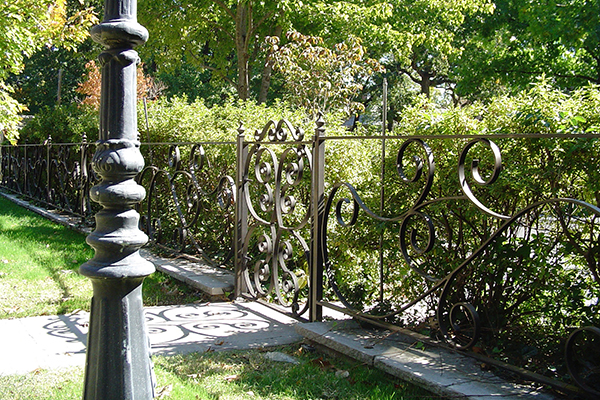Ornamental iron walk gate in garden space
