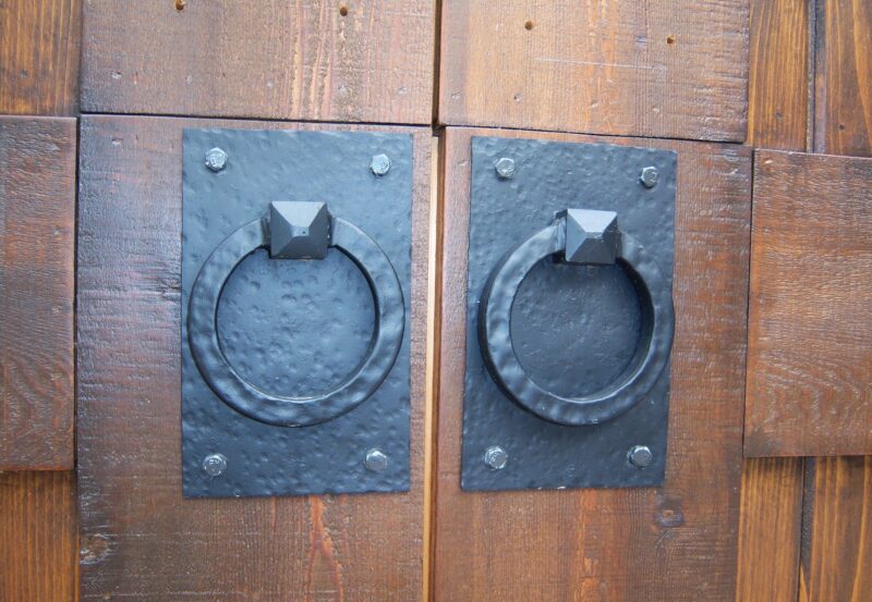 Photo of two iron wrought door handles.