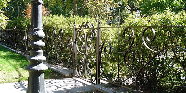 Ornamental iron walk gate in garden space